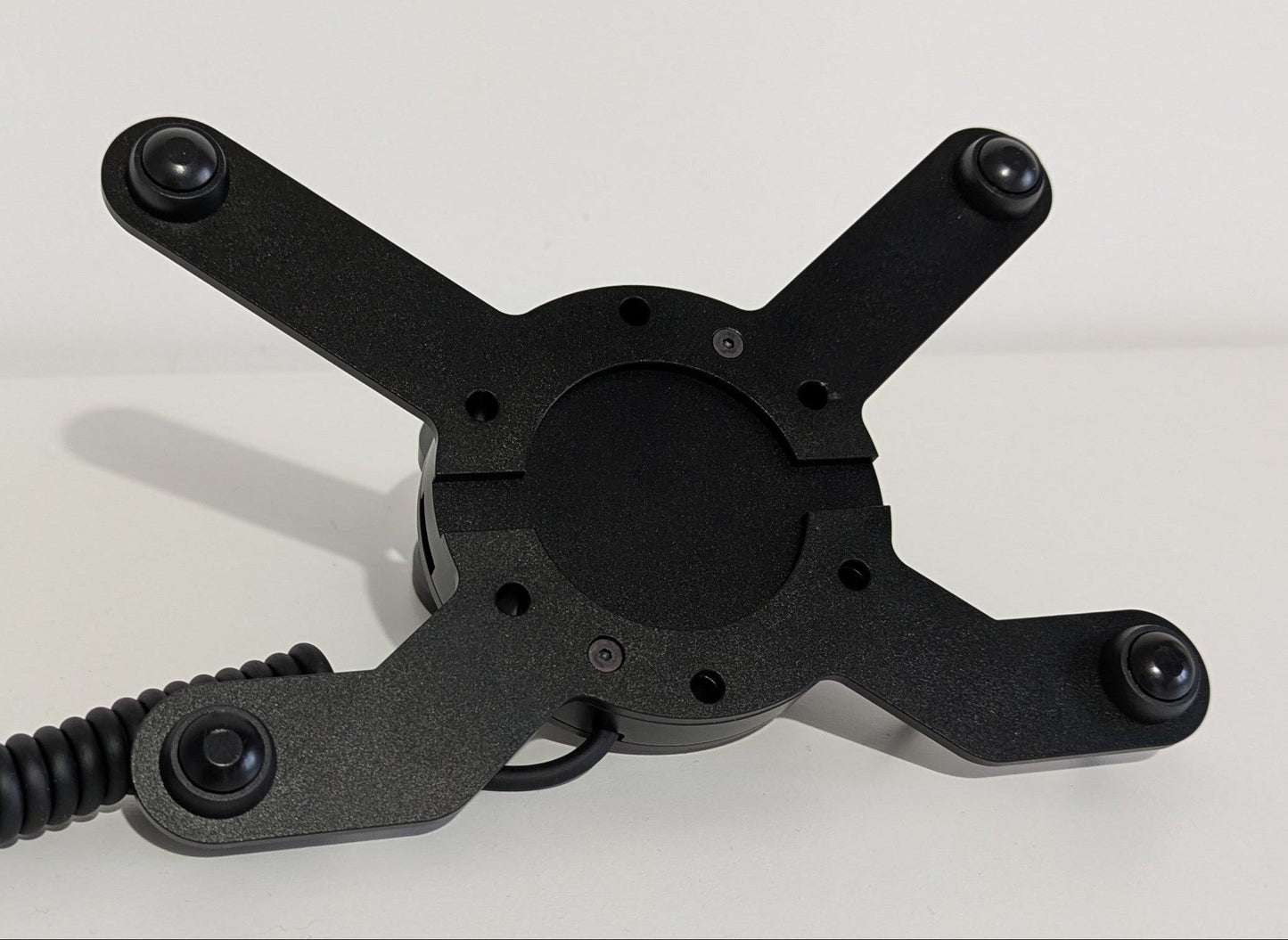 Front view of the JC wheel hub without the JC front plate The wheel hub has a bottom 2 button bracket with black buttons mounted and a top 2 2button bracket with black buttons mounted. The hub has a black coiled cable.
