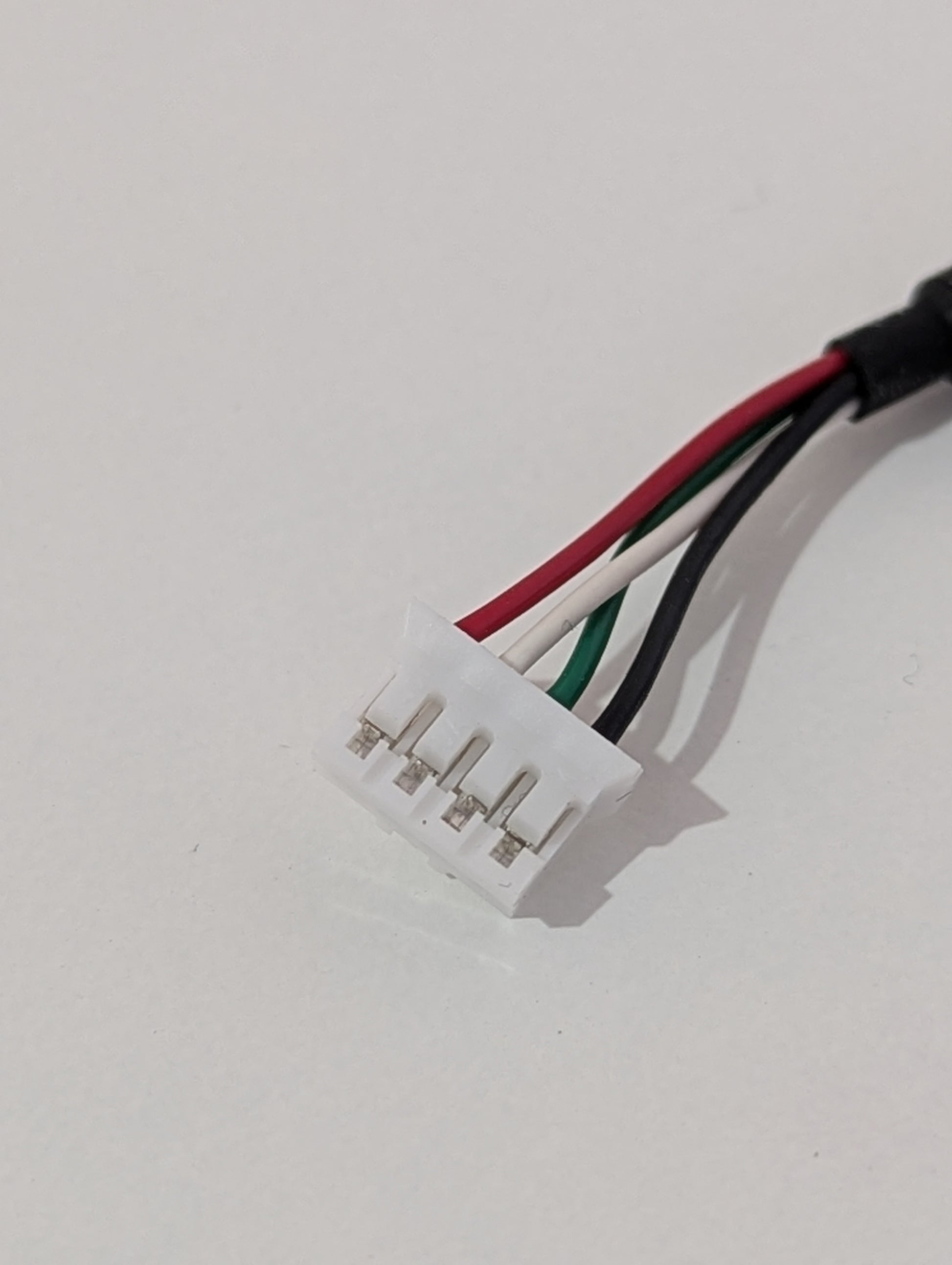 Wire connector with four wires on a white background