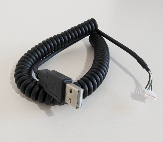 Coiled USB cable on a light gray background