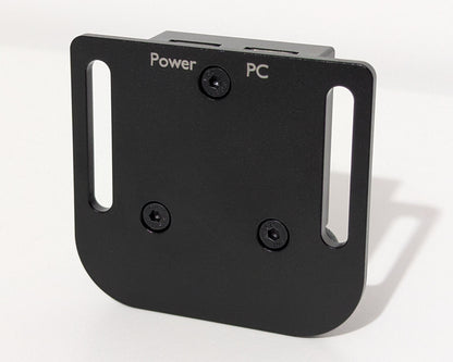 An image showing the underside of a small black device. The words Power and PC are engraved in the finish to indicate which port is used for which connection for the JCSS USB Power Injector
