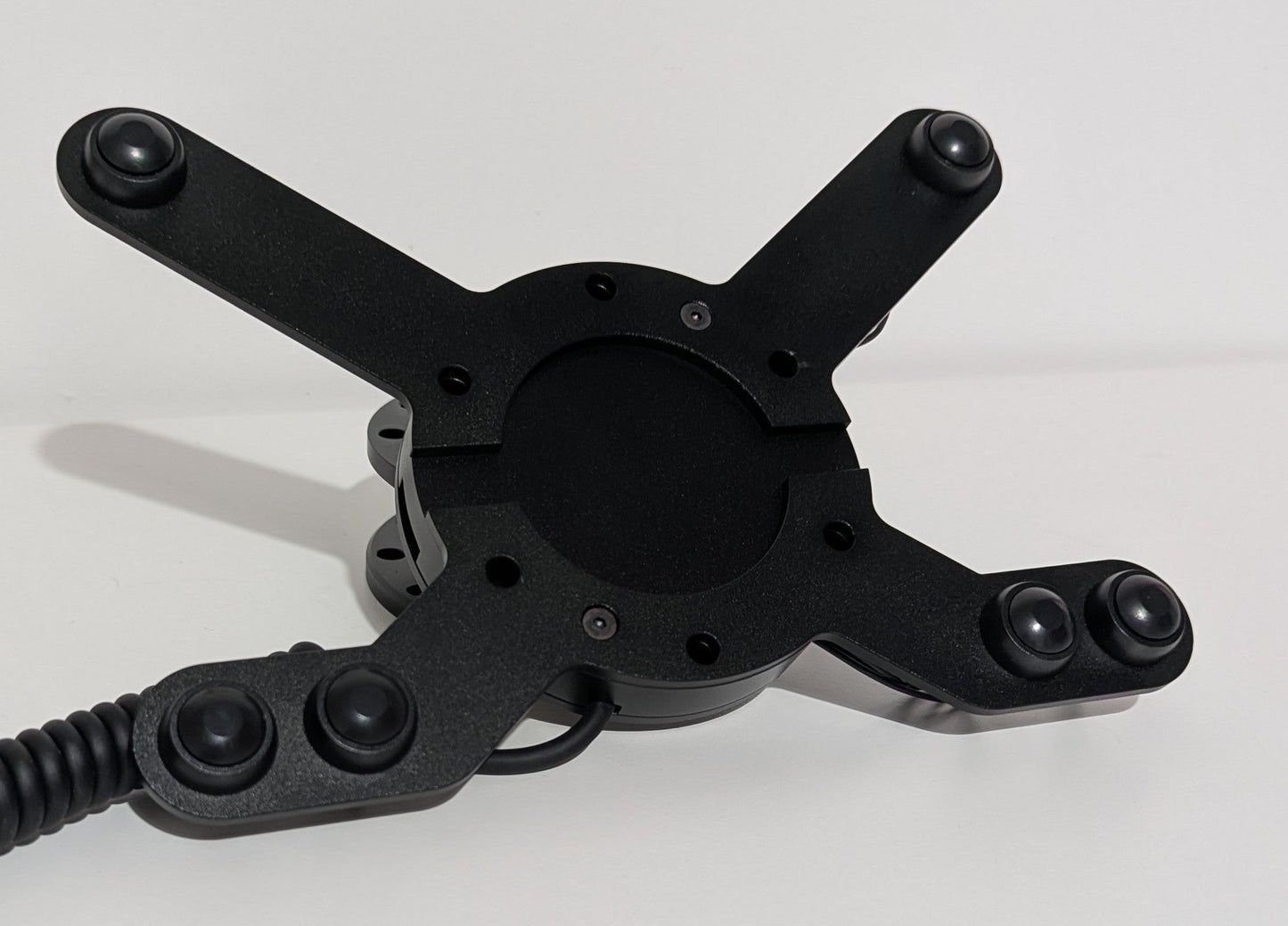 Front view of the JC wheel hub without the JC front plate The wheel hub has a bottom 4 button bracket with black buttons mounted and a top 2 button bracket with black buttons mounted.  The hub has a black coiled cable.