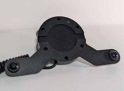 Front view of the JC wheel hub without the JC front plate The wheel hub has a bottom 2 button bracket with black buttons mounted.  The hub has a black coiled cable.