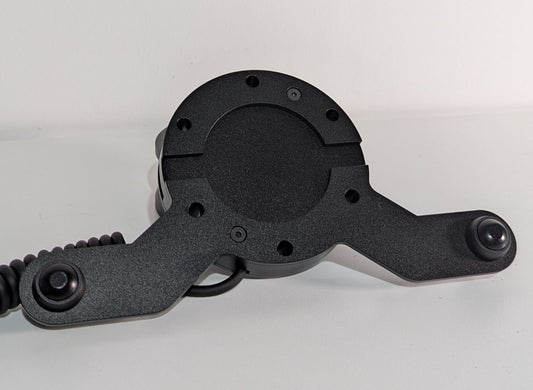 Front view of the JC wheel hub without the JC front plate The wheel hub has a bottom 2 button bracket with black buttons mounted.  The hub has a black coiled cable.